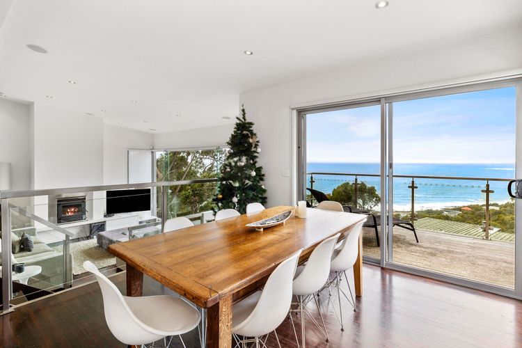 The elegant dining area is also nearby, which leads to a balcony with lounge chairs.