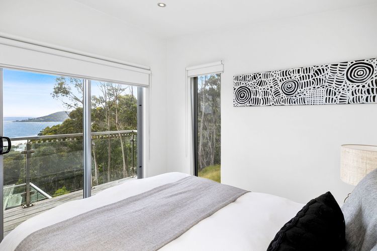 Bedroom 1: Queen bed, a walk-in robe, a private balcony, and an ensuite with a shower and toilet.