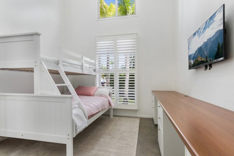 Bedroom 3 - This bedroom has a Single over Double Bunk bed, a built-in robe, an office desk, and a 42-inch TV.