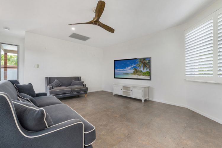 A large group can fit comfortably in the downstairs living room, which has an 85-inch Samsung TV.