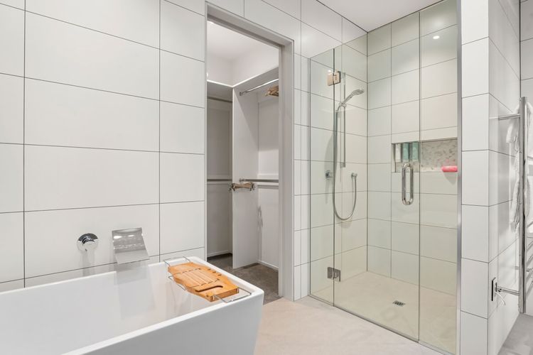 Ensuite bathroom with bathtub and walk-in wardrobe.