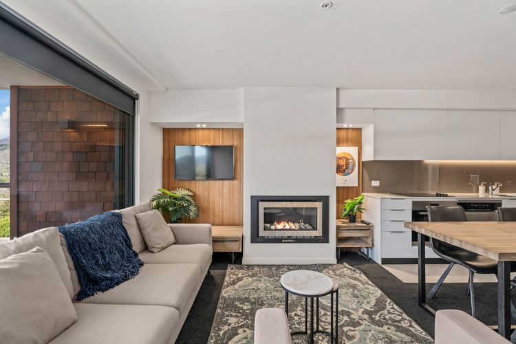 A cosy living space with gas fire, tv and views of the mountains!