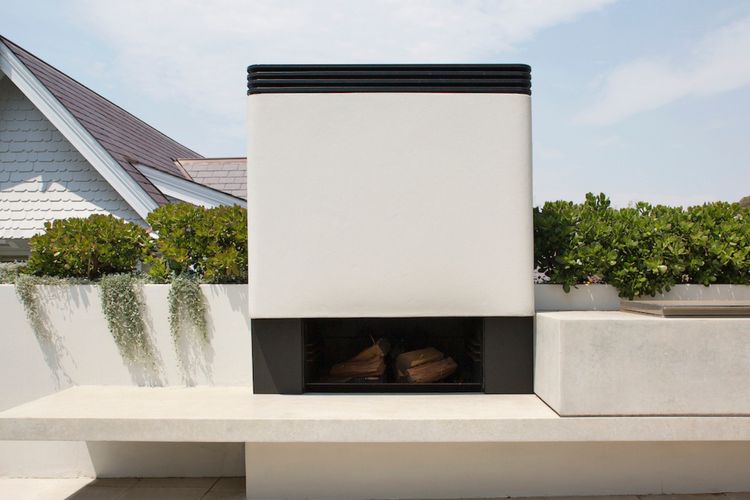 Sculptural elegance meets warmth at our outdoor fireplace.