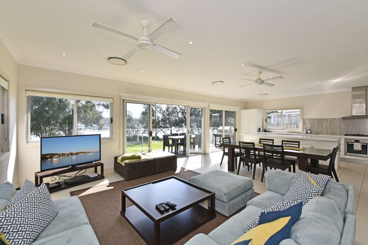 Lounge Room with Flat screen tv, dining 6 seats and lake view