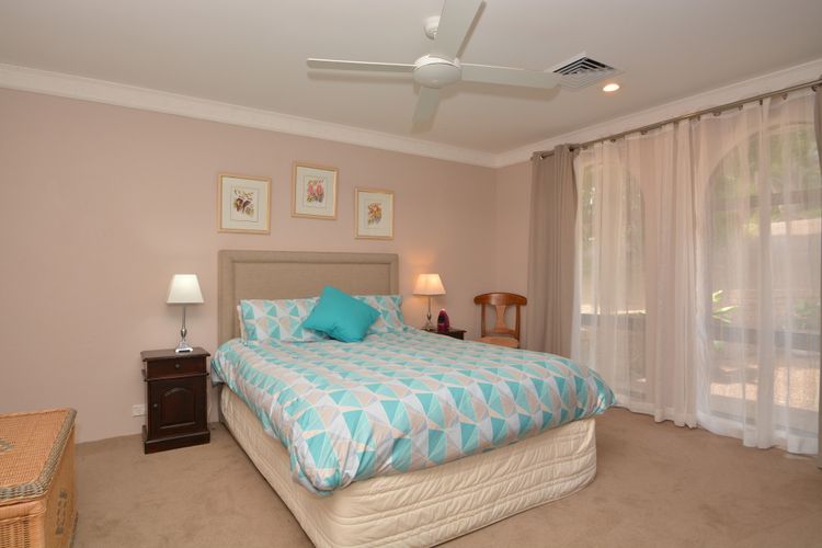Bedroom with queen bed and ceiling fan