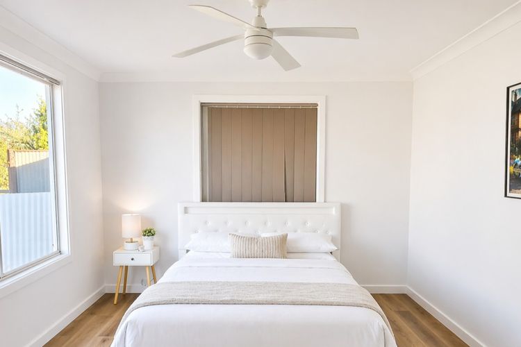 A peaceful main bedroom featuring a comfortable queen bed