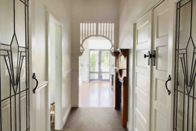 Old world charm in the lovely hallway leading to the open living area.