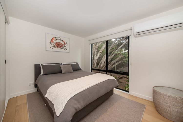 Bedroom three with queen bed and air con 