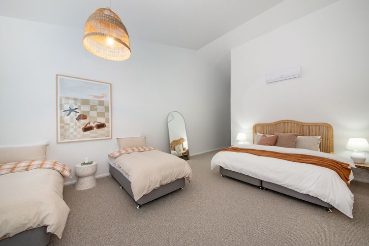 Bedroom one with king bed and two single beds 