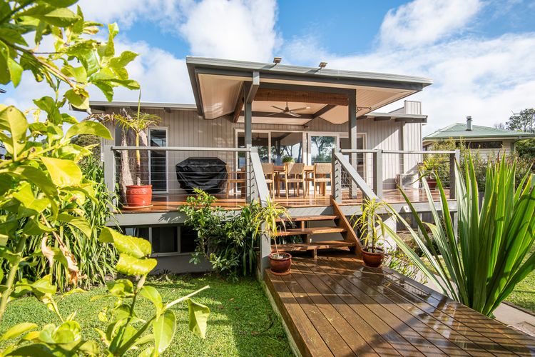 Balcony at the back of the house that leads to the back yard and pool area. out door dining for eight and bbq