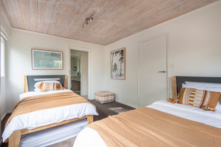 Downstairs bedroom with two king single beds and two single floor mattresses if required
