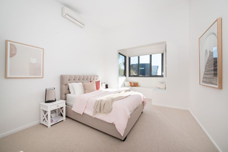 You're greeted by a plush, inviting bed  with soft, luxurious linens and an array of plush pillows.