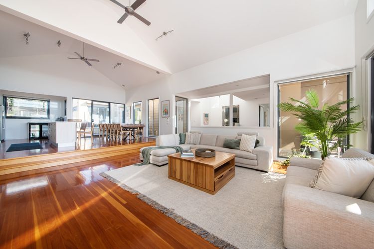 Step into our inviting living room, featuring a plush sofa adorned with soft throw pillows.