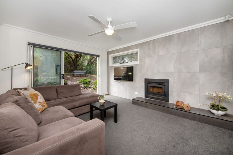 Downstairs living area with fireplace. Leads out to outdoor entertaining area 