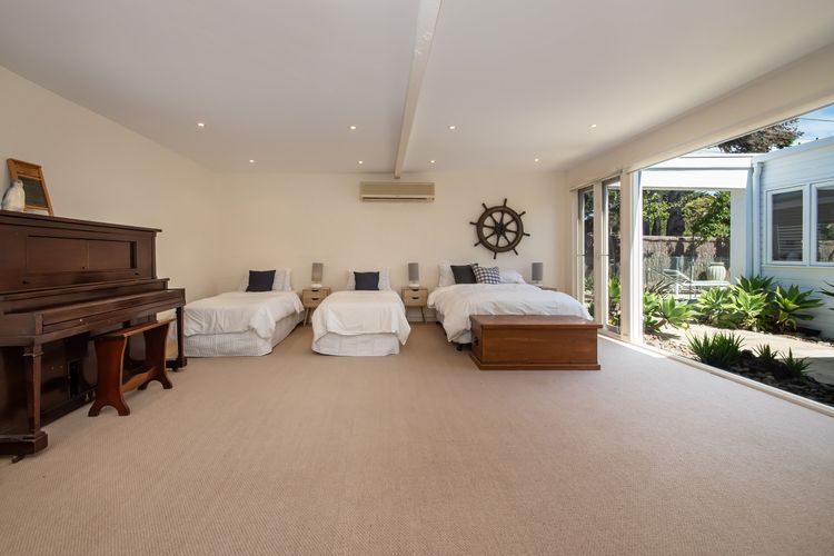Nautical Style bedroom 4 with 1 double bed and 2 single beds and has a nice view of outdoor.
