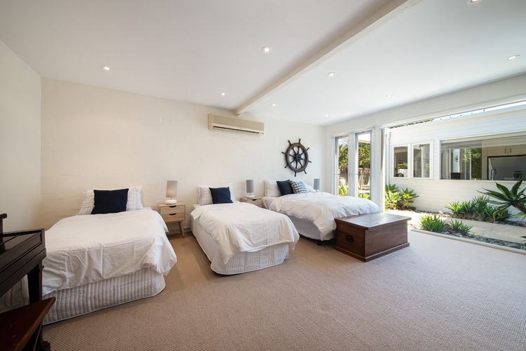 4th Bedroom with two single beds and a double bed