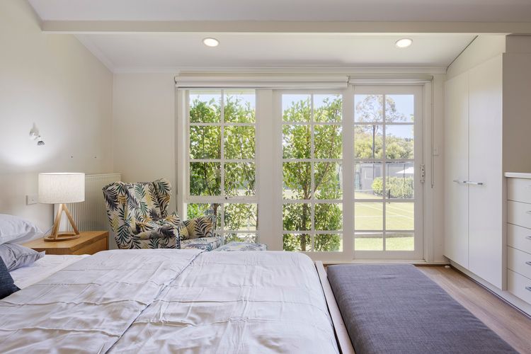 Bedroom two with king bed and views over the tennis court