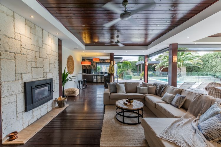 Outdoor living and dining with outdoor blinds. views of the pool, outdoor fireplace