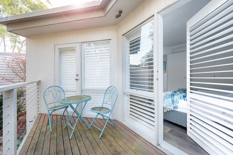 Bedroom two with a balcony and seating area 