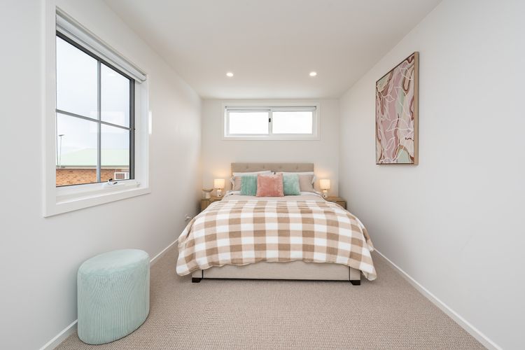 Upstairs, Bedroom 2 is furnished with a comfortable Queen bed.