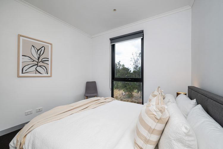 Bedroom one with queen bed and nature reserve view 