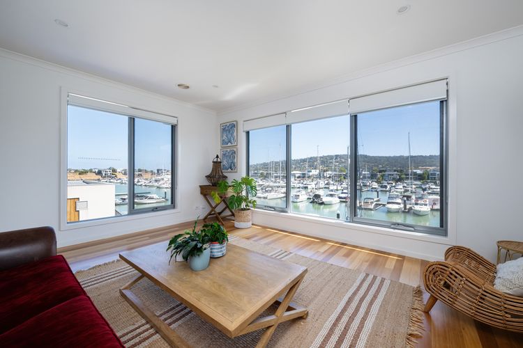 Upstairs Lounge area with a Tv a beautiful view over the Marina