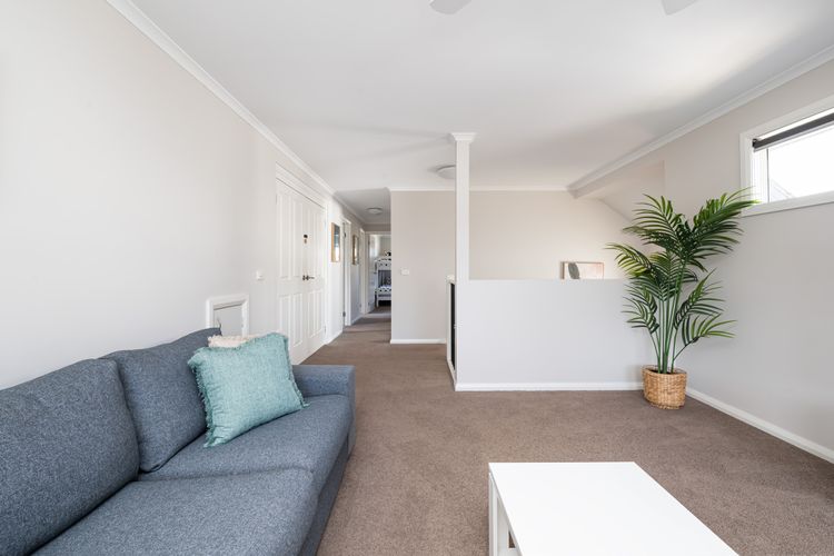 First floor living area with hallway leading to bedrooms two and three.