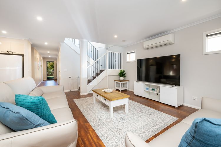 Open plan living area with split system and smart TV