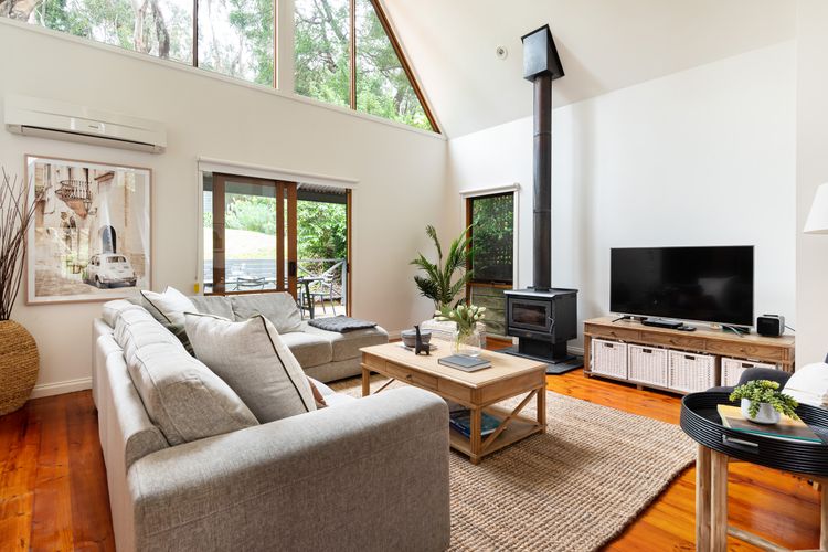 Relaxing lounge area with open fire and treetop views