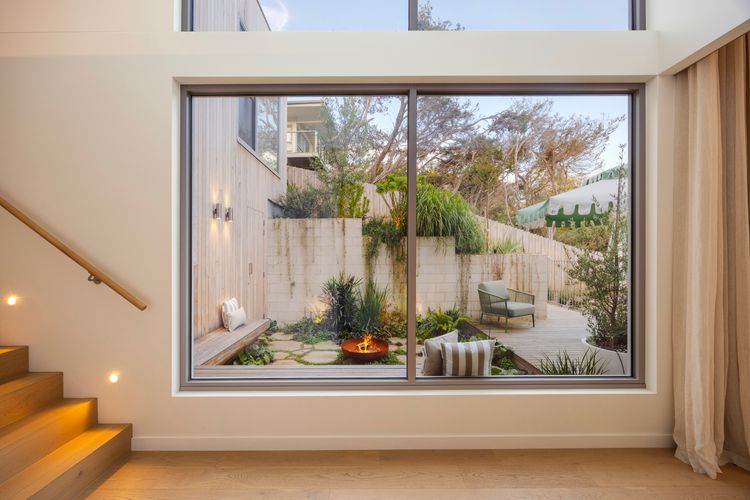 Soaring Ceilings and Windows overlooking Firepit area