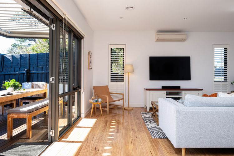 Living room with smart TV and access to outdoor dining area
