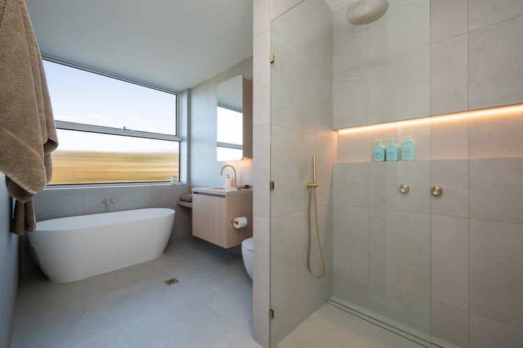 Main bathroom with tub, shower, and toilet