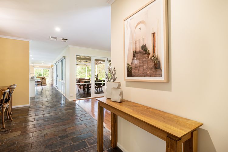 Step into the elegant hallway, where a sense of warmth and sophistication greets you immediately. 