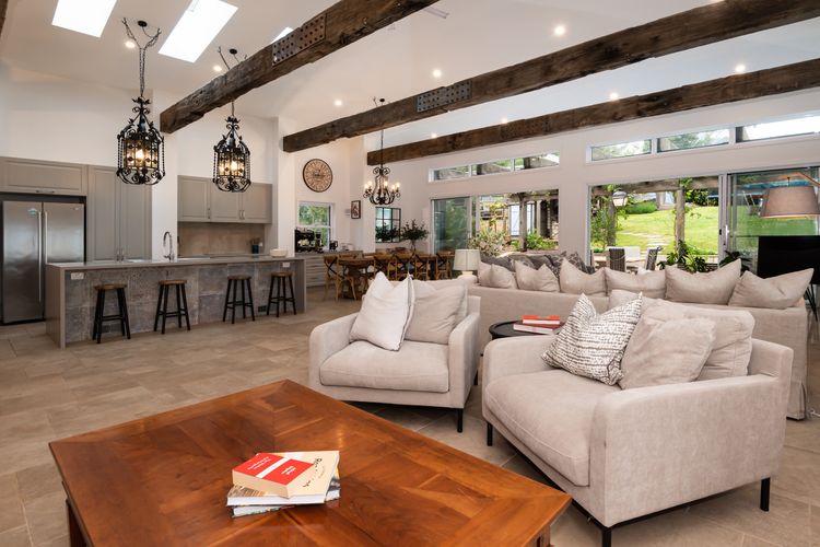 Main lving with stunning kitchen, wood fireplace and leading out to patio 