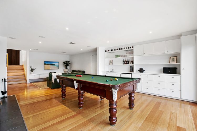 Second living space with a full sized billiard table and smart TV
