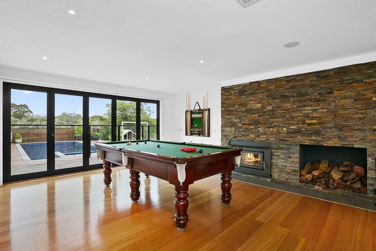 Second living space with a full sized billiard table and smart TV