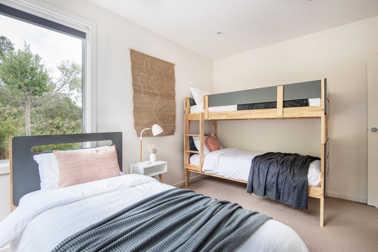 Bedroom with single bunk and single bed with a trundle 