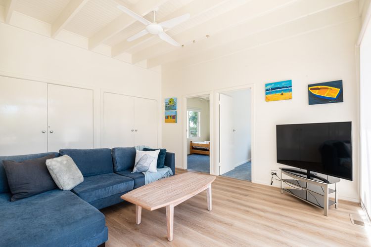 The living room is spacious and has a smart TV 