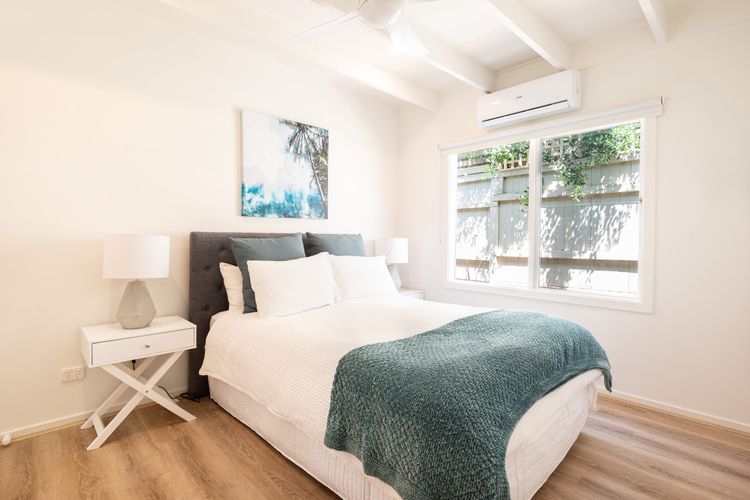 Bedroom 2 also has a queen bed and a split-type air conditioner 