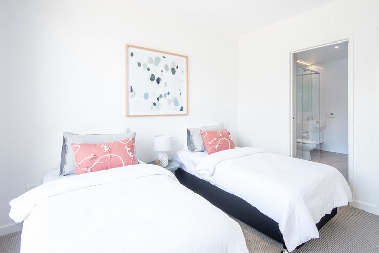 Bedroom Two: Two single beds with ensuite, TV and balcony access 