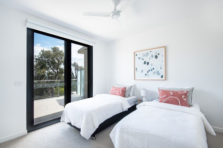 Bedroom Two: Two single beds with ensuite, TV and balcony access 