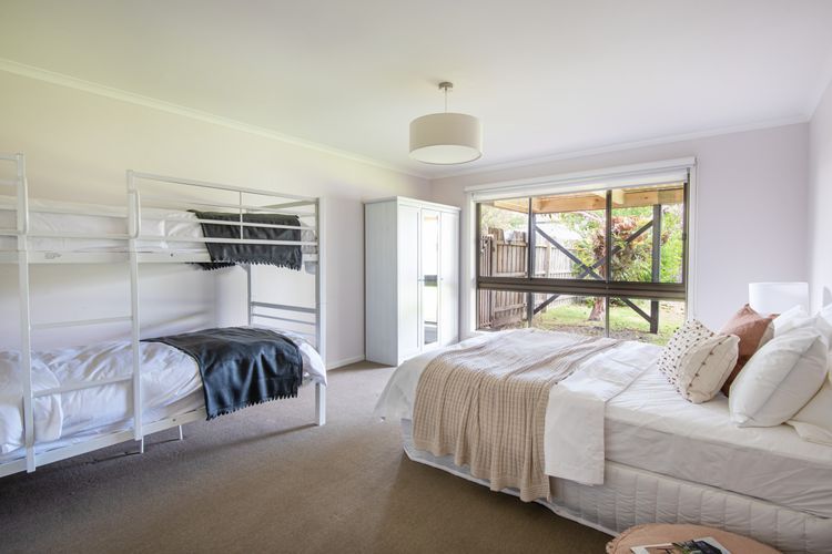 Downstairs bedroom with king bed and single bunk 