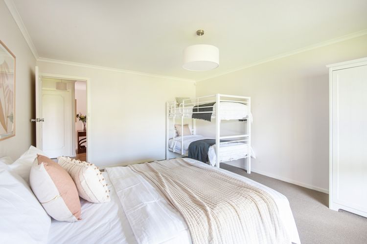 Downstairs bedroom with king bed and single bunk 