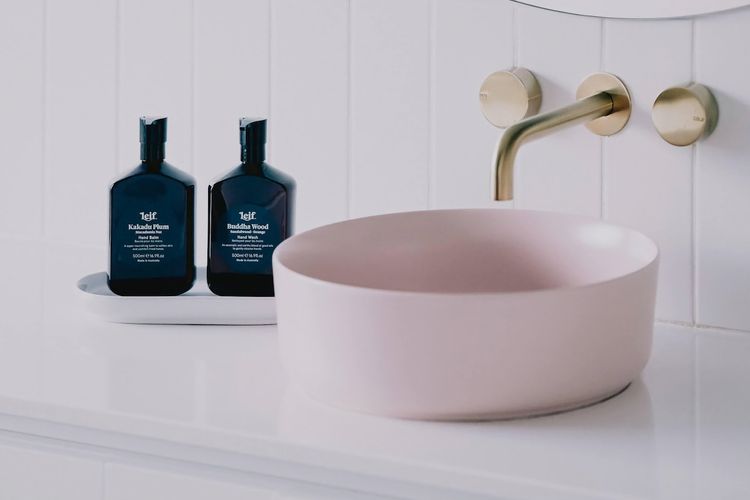 Middle floor bathroom - noted by its pink basin. Bathtub and shower. 