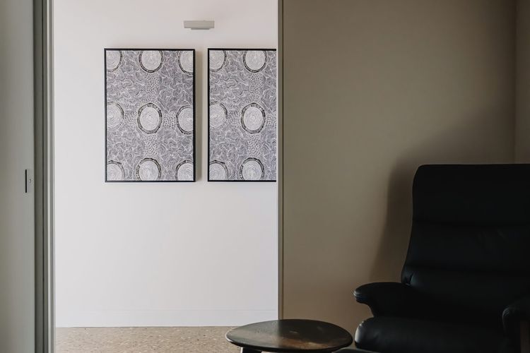 Secondary lounge room. Situated behind the kitchen. 
Readers armchair and floor lamp, secondary TV and two-seater lounge. 
