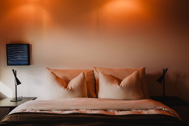 Bedrooms intentionally paired back - where natural materials, soft light, and a restrained palette create calm.