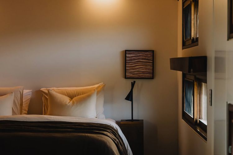 Bedrooms intentionally paired back - where natural materials, soft light, and a restrained palette create calm.