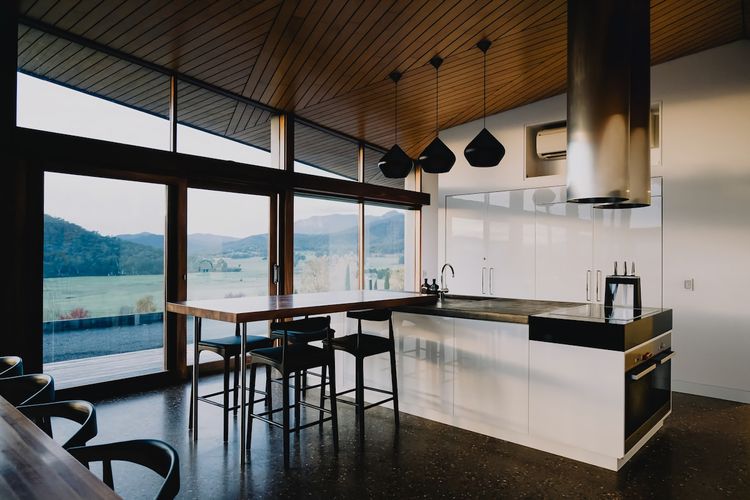 Kitchen // breakfast bar.
Stove top and ovens are visible on the end of the bench area.
