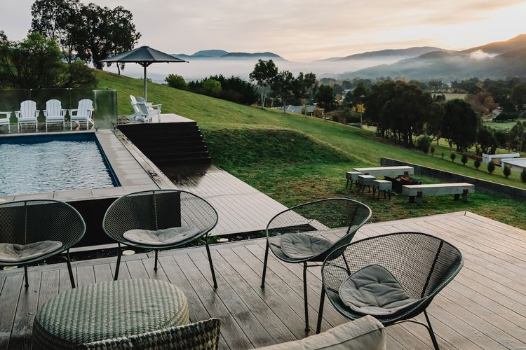 Expansive decks extend the indoor living spaces outward, offering relaxed areas for dining and lounging in every season.