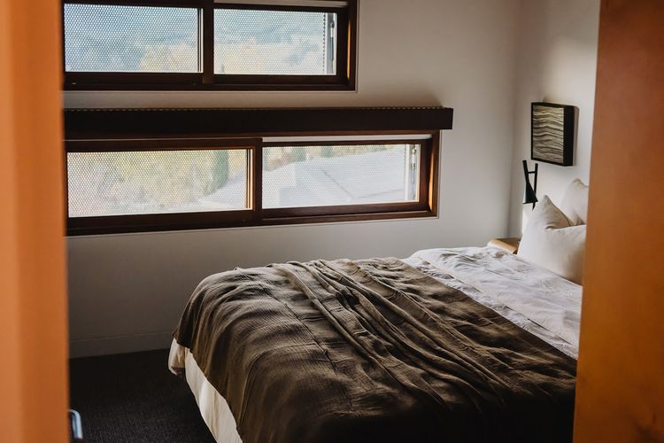 Bedrooms intentionally paired back - where natural materials, soft light, and a restrained palette create calm.
